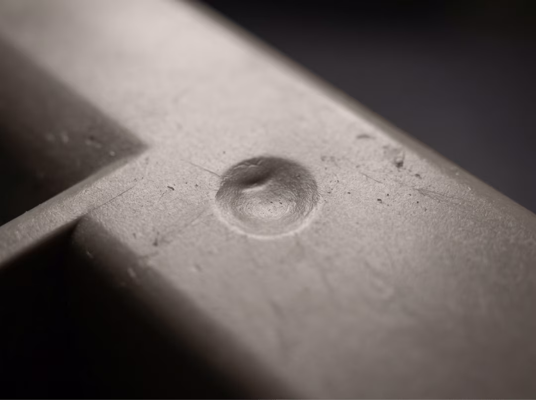 Sink mark defect on a molded plastic part Sink mark defect on a molded plastic part